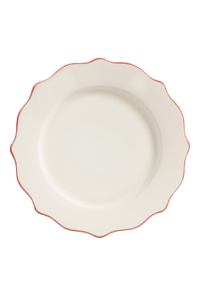White ceramic plate with a red rim on a white background