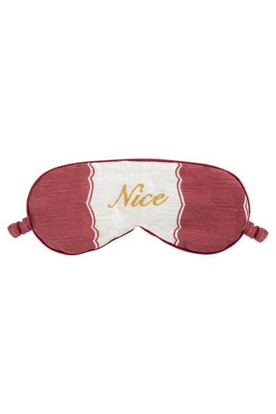 Sleep mask with 'Nice' text on a white background